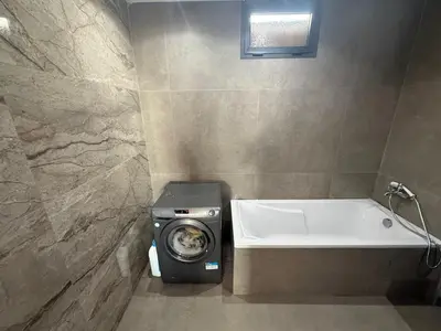 a bathroom with a washing machine and a bath tub at studio elevator, renovated air-conditioned breakfast in Casablanca