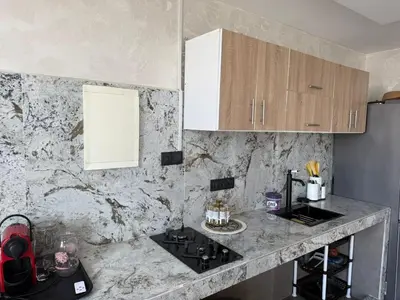 a kitchen with a granite counter top and a sink at studio elevator, renovated air-conditioned breakfast in Casablanca