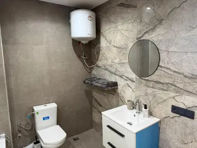 a bathroom with a toilet and a sink and a mirror at studio elevator, renovated air-conditioned breakfast in Casablanca