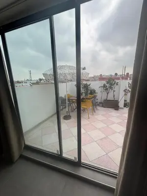 a view of a patio from an open window at studio elevator, renovated air-conditioned breakfast in Casablanca