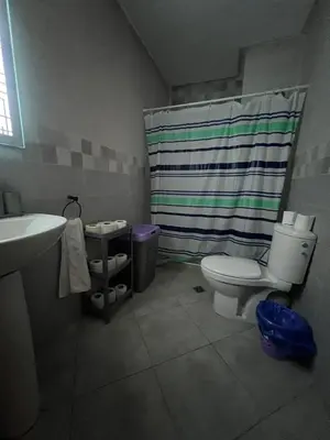 a bathroom with a toilet and a shower curtain at Cozy appartement avec piscine in Bouznika