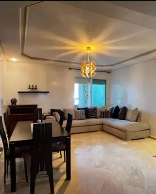 a living room with a couch and a table at Family appartment in Casablanca