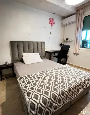 a bedroom with a bed with a pink flower on the wall at Family appartment in Casablanca