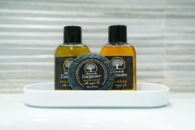 two bottles of hair products sitting on a shelf at Studio Paisible aux Hopitaux Wifi & Parking in Casablanca