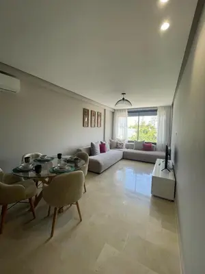 a living room with a table and a couch at Cozy studio for rent Casablanca in Casablanca