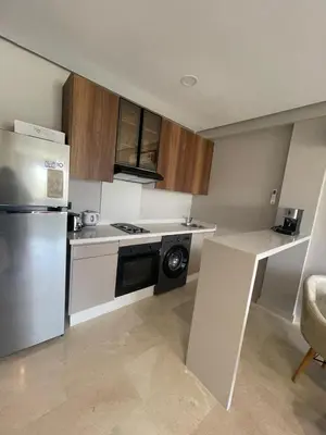 a small kitchen with a refrigerator and a stove at Cozy studio for rent Casablanca in Casablanca