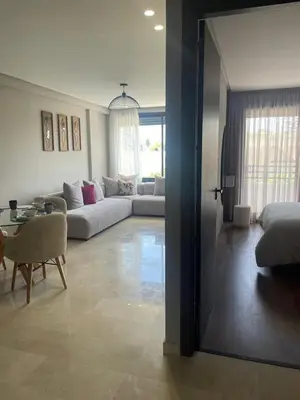a living room with a couch and a table at Cozy studio for rent Casablanca in Casablanca
