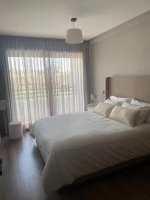 a bedroom with a large bed and a large window at Cozy studio for rent Casablanca in Casablanca