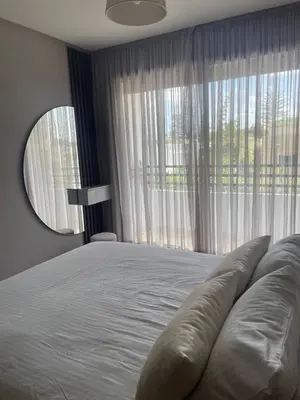 a bedroom with a large bed with a large window at Cozy studio for rent Casablanca in Casablanca