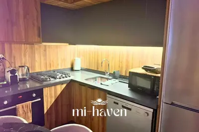 a kitchen with a sink and a microwave at Happy - 2 BR - Downtown Casablanca in Casablanca