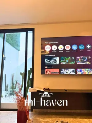 a flat screen tv on a wall in a room at Happy - 2 BR - Downtown Casablanca in Casablanca