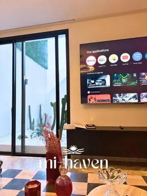 a living room with a tv and a checkered table at Happy - 2 BR - Downtown Casablanca in Casablanca