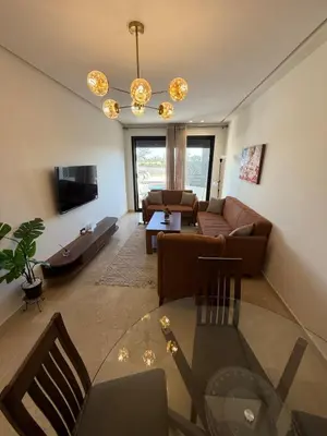a living room with a couch and a chandelier at Cozy studio for rent for respectful family couple in Casablanca