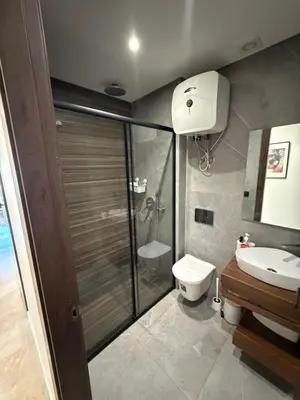 a bathroom with a shower and a toilet and a sink at Cozy studio for rent for respectful family couple in Casablanca