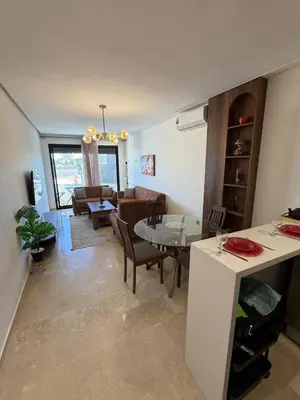 a living room with a table and a dining room at Cozy studio for rent for respectful family couple in Casablanca