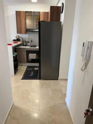 a kitchen with a refrigerator in the middle of a room at Cozy studio for rent for respectful family couple in Casablanca
