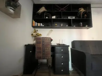 a bedroom with a desk and a dresser and a bed at Cozy Rabat Studio near Tram & City Center in Rabat