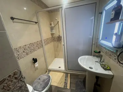 a bathroom with a shower and a toilet and a sink at Cozy Rabat Studio near Tram & City Center in Rabat