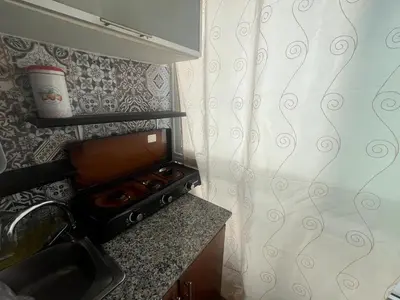 a small kitchen with a stove and a sink at Cozy Rabat Studio near Tram & City Center in Rabat