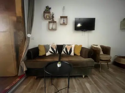 a living room with a couch and a table at Cozy Rabat Studio near Tram & City Center in Rabat