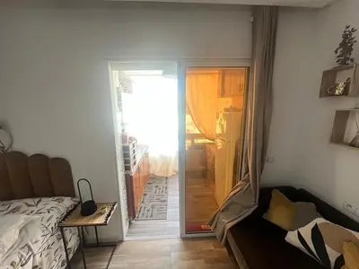a bedroom with a bed and a sliding glass door at Cozy Rabat Studio near Tram & City Center in Rabat