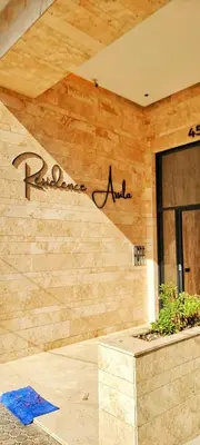 a building with a sign on the side of it at Les-iris-Appartement-moderne-chambre-salon-au-cœur-de-Casablanca in Casablanca