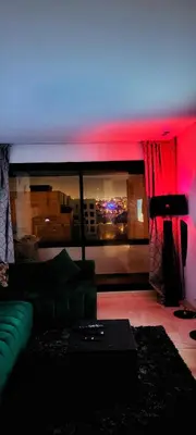 a living room with a couch and a view of a city at Les-iris-Appartement-moderne-chambre-salon-au-cœur-de-Casablanca in Casablanca