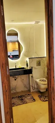 a bathroom with a toilet and a sink at Les-iris-Appartement-moderne-chambre-salon-au-cœur-de-Casablanca in Casablanca