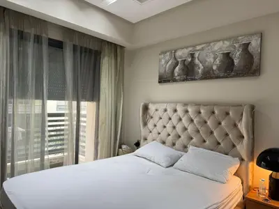a bedroom with a bed and a large window at Urban Square in Casablanca