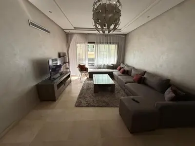 a living room with a couch and a table at Urban Square in Casablanca