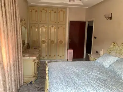 a bedroom with a large bed and a dresser at Grand Andalusian Villa Private Garage and Garden in Casablanca