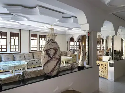 a large living room with a couch and a tub at Grand Andalusian Villa Private Garage and Garden in Casablanca