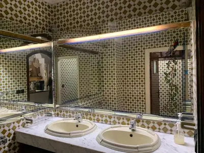 a bathroom with two sinks and a large mirror at Grand Andalusian Villa Private Garage and Garden in Casablanca
