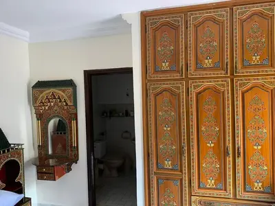 a large wooden door in a room with a mirror at Grand Andalusian Villa Private Garage and Garden in Casablanca