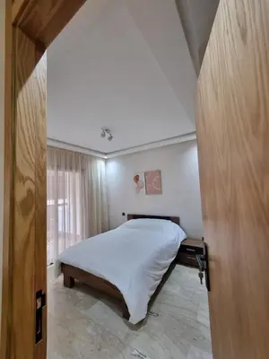 a bedroom with a bed and a large window at Maarif Cosy Studios in Casablanca