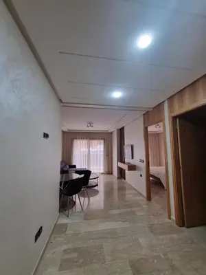 a living room with a table and a dining room at Maarif Cosy Studios in Casablanca