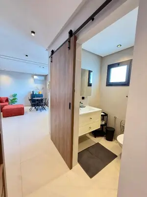 a bathroom with a sliding door leading into a room at Appartement moderne et chaleureux au cœur de Rabat in Rabat