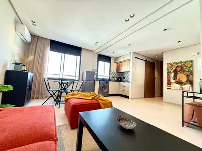 a living room with a couch and a table at Appartement moderne et chaleureux au cœur de Rabat in Rabat