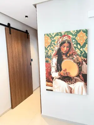 a painting of a woman holding a plate in a hallway at Appartement moderne et chaleureux au cœur de Rabat in Rabat