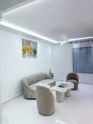 a living room with a couch and two chairs and a table at Charming 3 bedroom with pool in the building in Casablanca