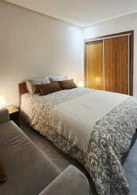 a bedroom with a large bed and a large window at Appartement modern tramway in Casablanca