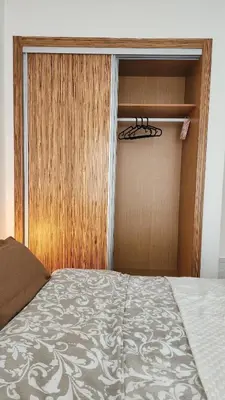 a bedroom with a closet with a bed and a door at Appartement modern tramway in Casablanca