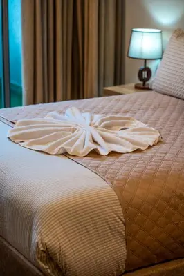 a bed with a dress on top of it at L'Amber 1 chambre - 5 min de l'Aéroport- Piscine in Nouaseur
