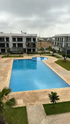 a large blue swimming pool in front of a building at Appartement Résidence Tamaris Park in Tamaris