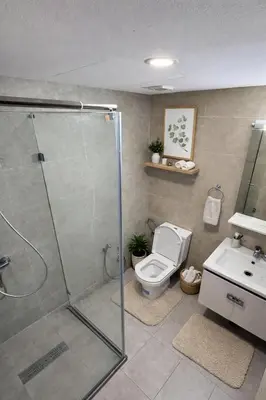 a bathroom with a shower and a toilet and a sink at Appartement Résidence Tamaris Park in Tamaris