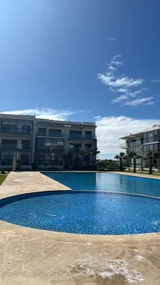 a large swimming pool in front of a building at Appartement Résidence Tamaris Park in Tamaris