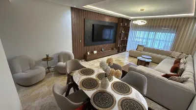 a living room with a couch and a table at Appartement Résidence Tamaris Park in Tamaris