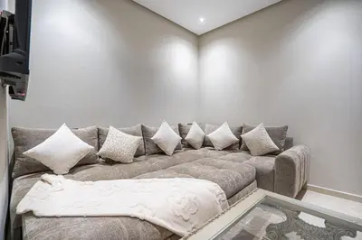 a living room with a couch with pillows at Luxury Residence Beach Gym and Garage in Pont Blondin