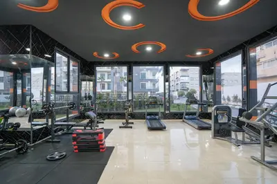 a gym with treadmills and machines in a building at Luxury Residence Beach Gym and Garage in Pont Blondin
