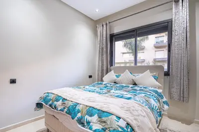 a bedroom with a large bed with a window at Luxury Residence Beach Gym and Garage in Pont Blondin